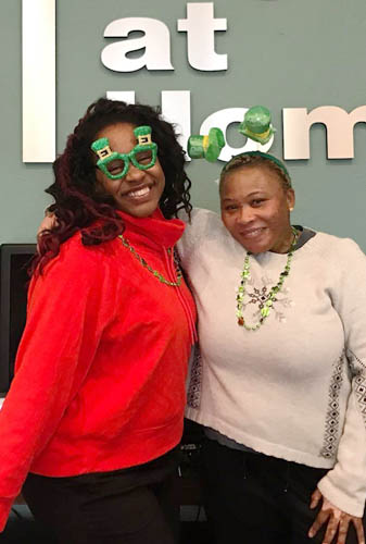 Two Women Posing Side-by-Side with St. Patrick's Day Face Paint and Costume Jewelry