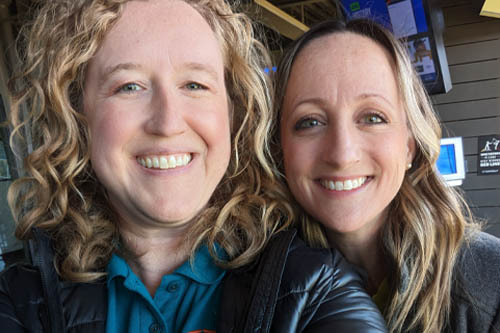 Right at Home Female Staff Members Posing Side-by-Side Smiling at the Camera