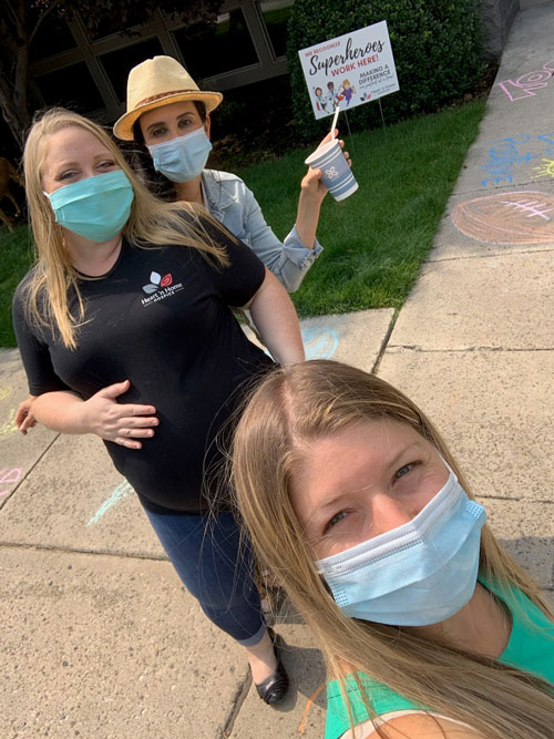 Caregivers making chalk art