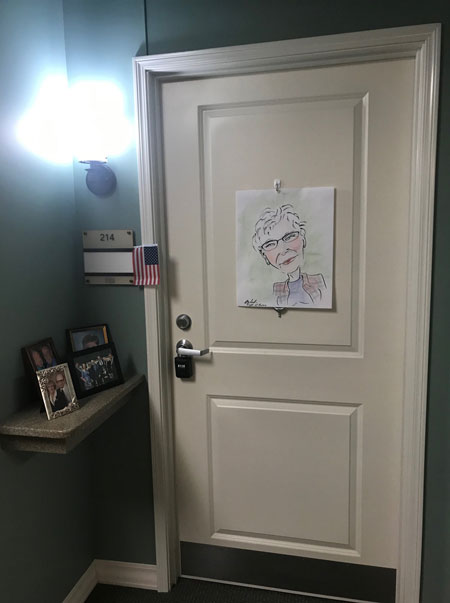 Door with caricature drawing hung up on it.