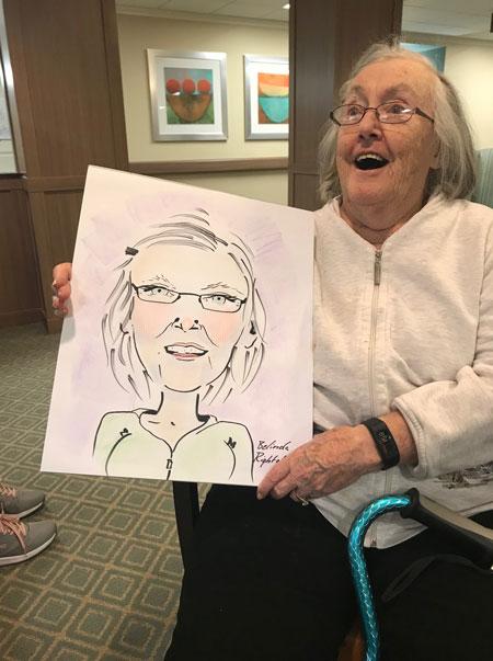 Senior holding caricature picture