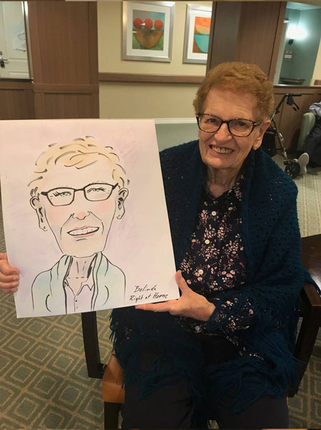 Senior holding caricature picture