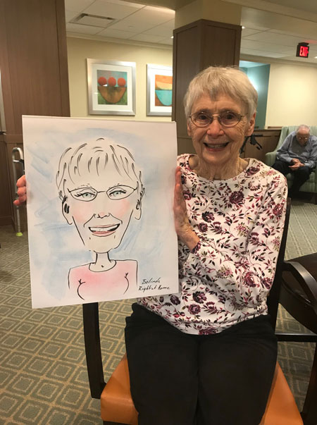 Senior holding caricature picture