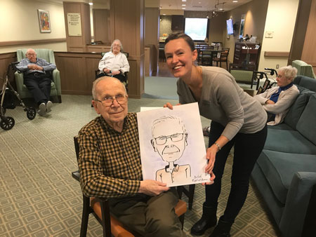 Senior holding caricature picture