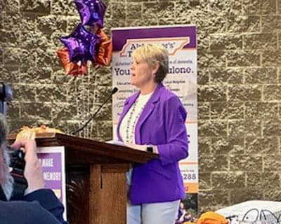 Pam Reeves speaking at a podium