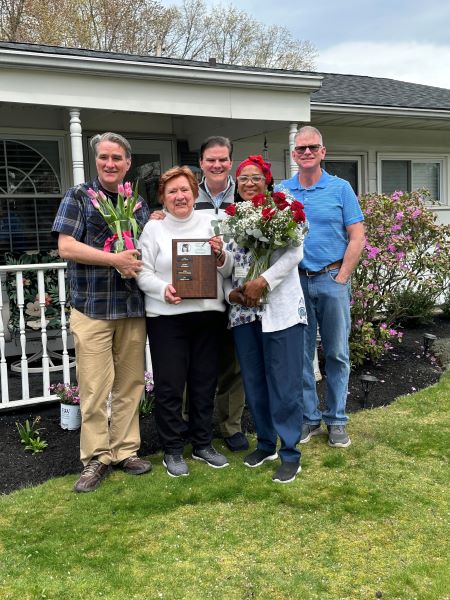 Martha and Kathleen Malloy's family with the award