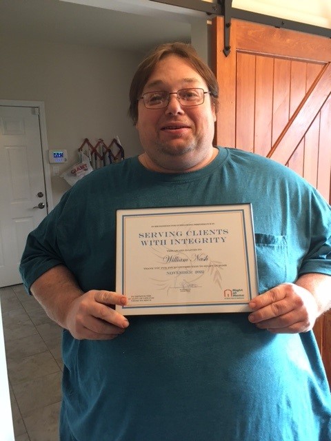 Bill Nash, caregiver, holding a certificate