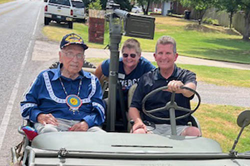 Native American and WWII Veteran Centenarian Veteran Sitting in WWII Jeep with Two Other Men as the Bethany Parade Grand Marshal
