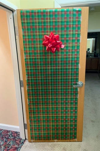 Caregivers and seniors in the community enjoy decorating their doors to look like Christmas presents