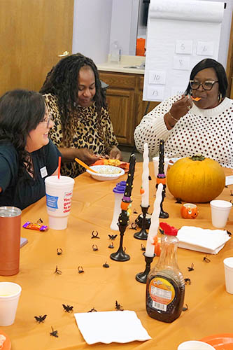 Caregivers enjoying food and fun at our annual Halloween caregiver appreciation gathering