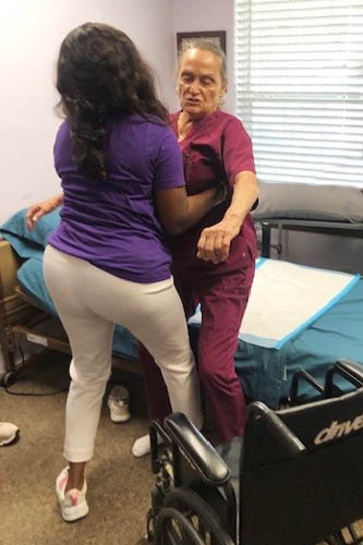 Female Caregiver Training with a Mannequin for Bed Transitions