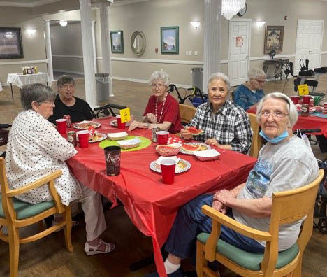SW Mansions Cook Out-Seniors at Dining Table