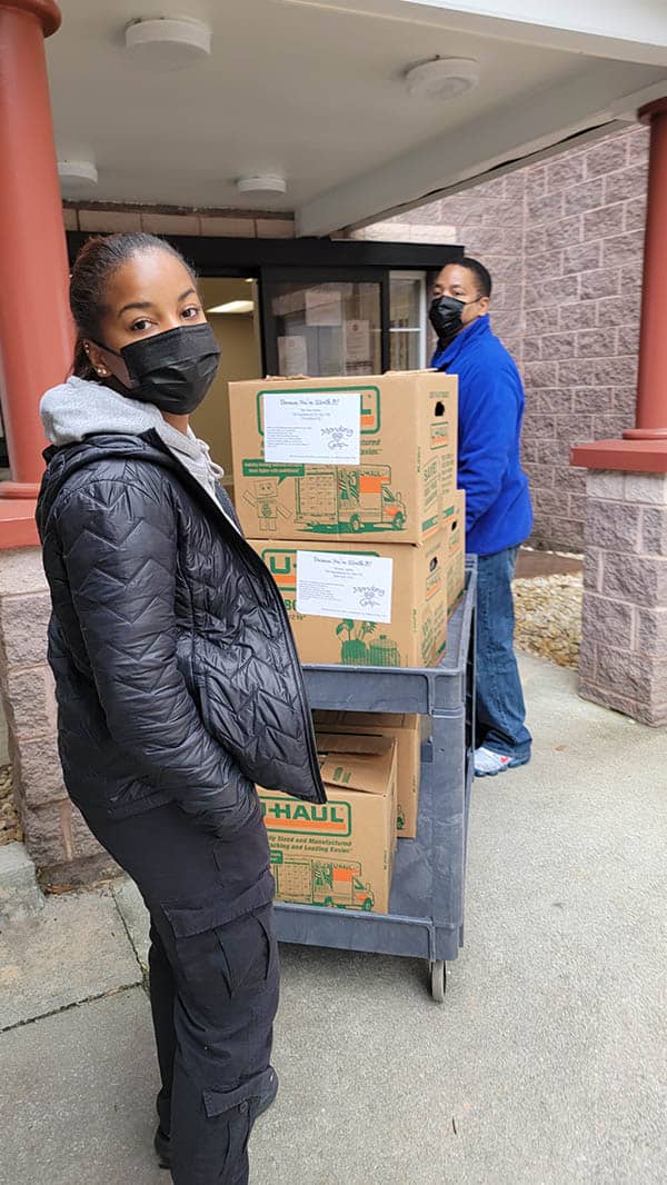 Mikayla and Mark Ross helping move boxes