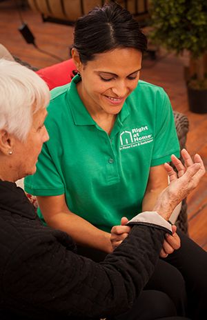 Caregiver rolling up sleeves of client