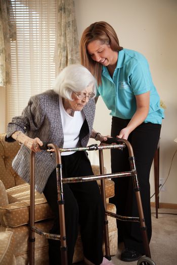 Caregiver helping senior up