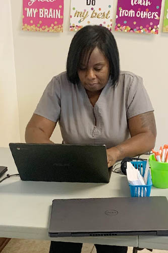 Female Caregiver Hard at Work on the Computer at HCP Training