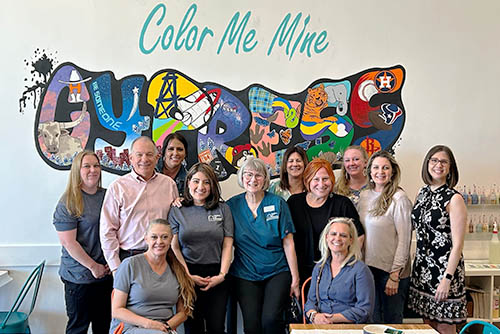 Group photo of attendees of the Color Me Mine team building activity