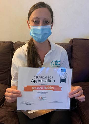 Jessica Hobbs holding her caregiver of the month certificate for July 2021 - Right at Home Plainview, NY