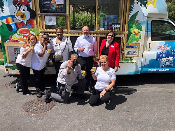 Gregg Balbera along with six staff members of Bristal East Northport in front of the Kona Ice truck