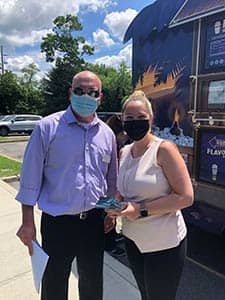 Gregg Balbera and a staff members at Carillon Rehab waiting at the Kona Ice truck