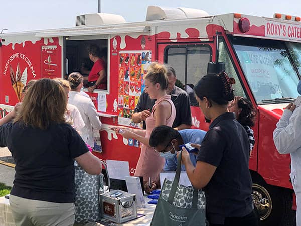 Staff members at St. Catherine's Hospital and Rehab waiting for an ice cream from Roxy's Catering