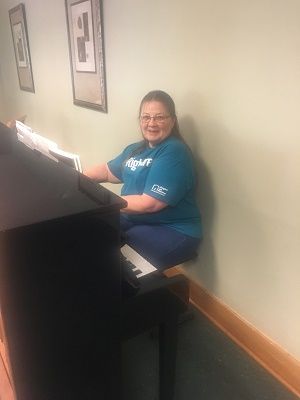 Right at Home Clarksville,TN Caregiver, Diana, playing piano at Mother's Day Tea 