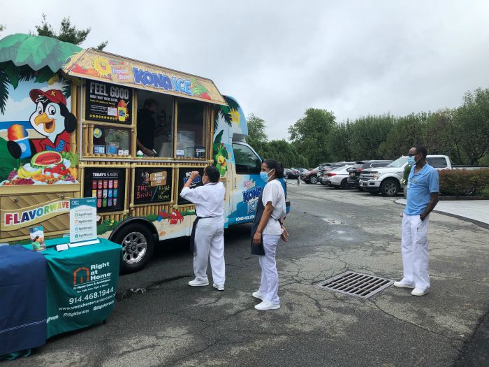 staff from king street rehab waiting for free kona ice from right at home westchester