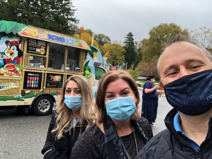 Right at Home Westchester, NY Owner Lou Giampa and two females posing in front of the kona ice truck at St. Cabrini Nursing Home in Dobbs Ferry, NY