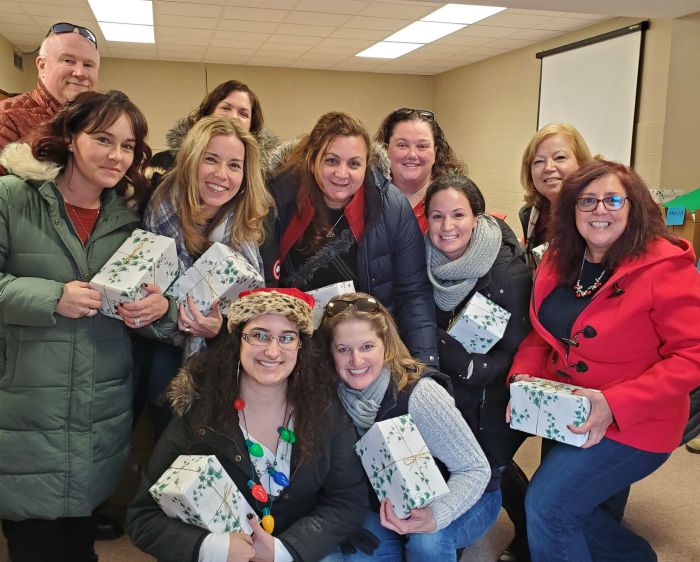 group of right at home boston north staff holding Christmas presents