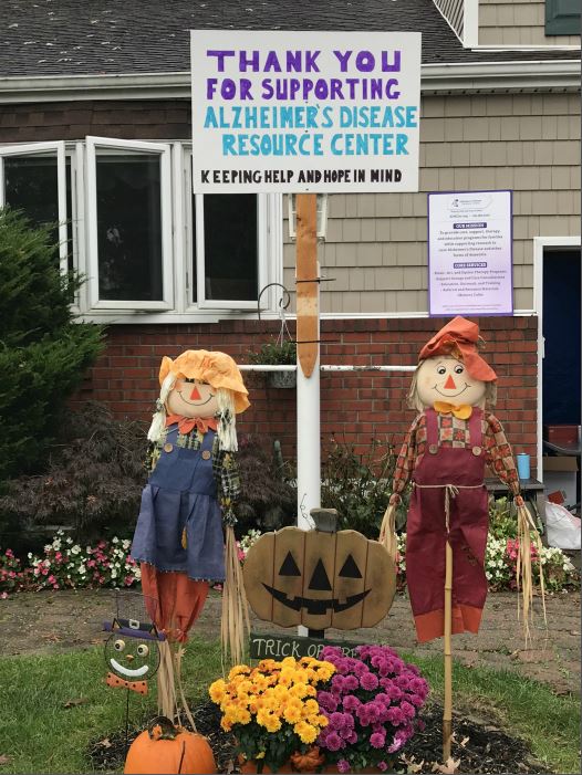Right at Home South Shore Long Island at the ADRC Fundraiser Yard sale for their virtual walk to end Alzheimer's. Two scarecrows and signage about the event.