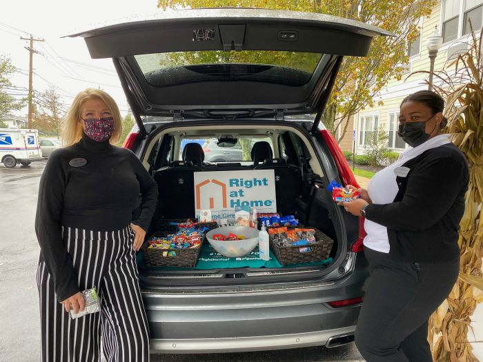 Right at Home South Shore Long Island delivering refreshments to front line workers at the Bristal North Woodmere assisted living communities with a “snackmobile”. Two females standing behind Right at Home vehicle with snacks in the back.