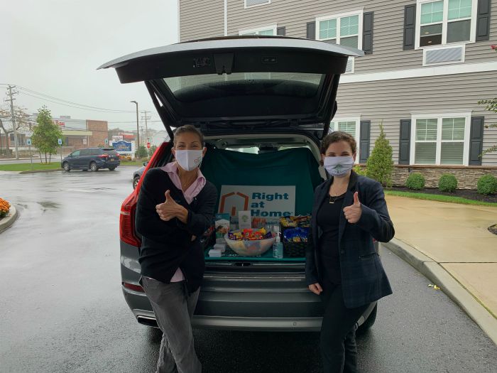 Right at Home South Shore Long Island delivering refreshments to front line workers at the Bristal West Babylon assisted living communities with a “snackmobile”. Two females standing behind Right at Home vehicle with snacks in the back.