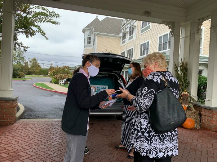 Right at Home South Shore Long Island Owner Jeanine Gagliano talking to two ladies while delivering refreshments to front line workers at the Sunrise West Babylon assisted living community with a “snackmobile”. 