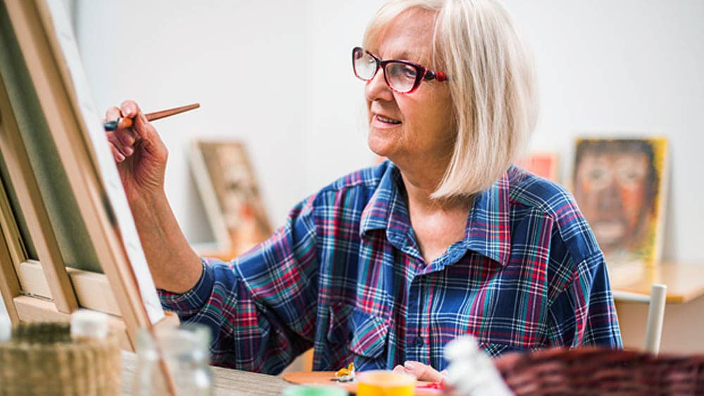 Senior Woman Painting on Canvas