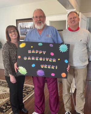 Caregiver Dave Monroe standing with Doddie Brooks and Pete Lawrence