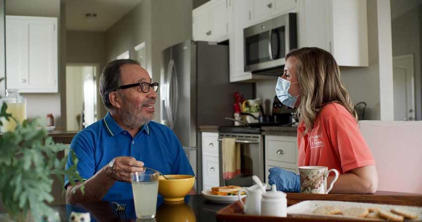 A Shorewood, Wisconsin female caregiver having lunch with a male client.