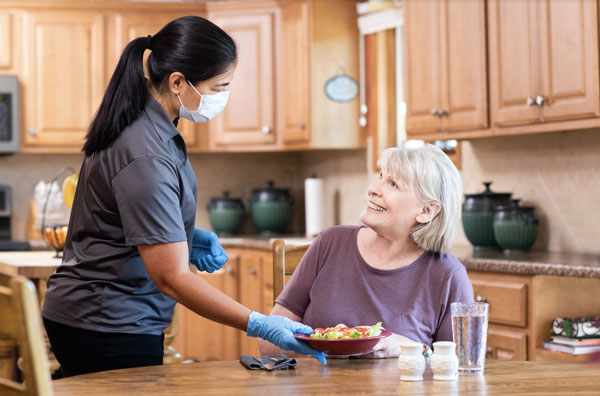 Caregiver serving food to client