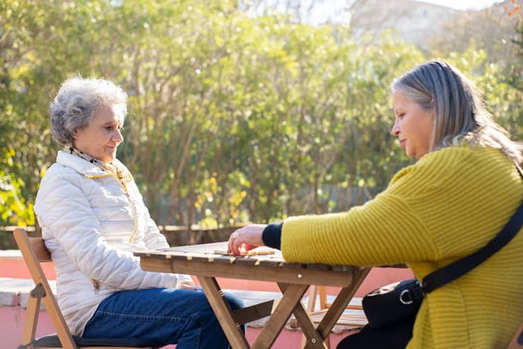 women-playing-dominos on porch