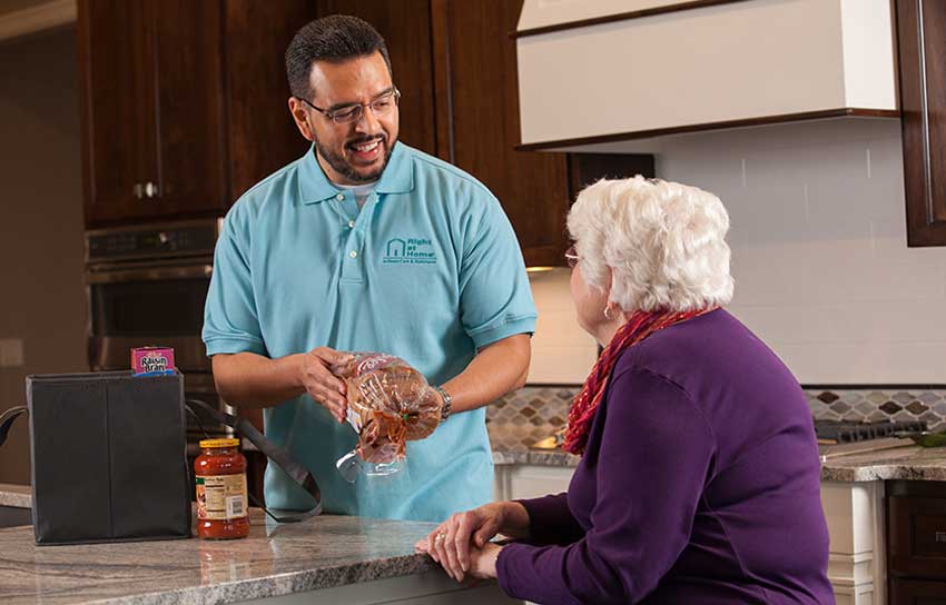 Caregiver unpacking groceries