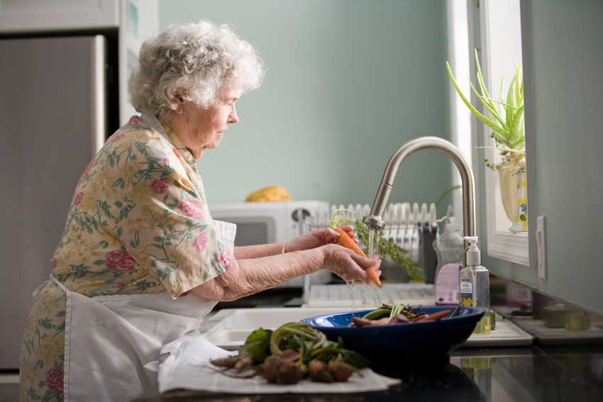 Elder Senior washing vegetables