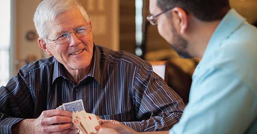 Right at Home caregiver playing cards with client