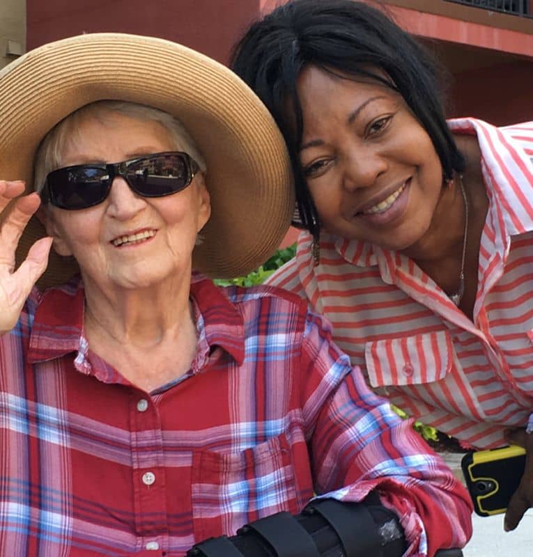 Caregiver smiling with senior client on a sunny afternoon