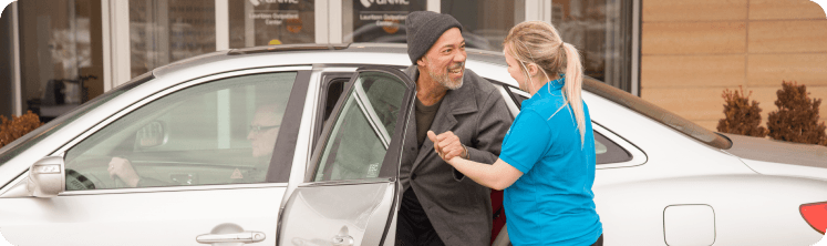 Caregiver helping client out of the car