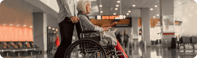 Caregiver pushing client in wheelchair 