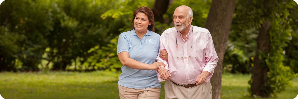 man and caregiver walking