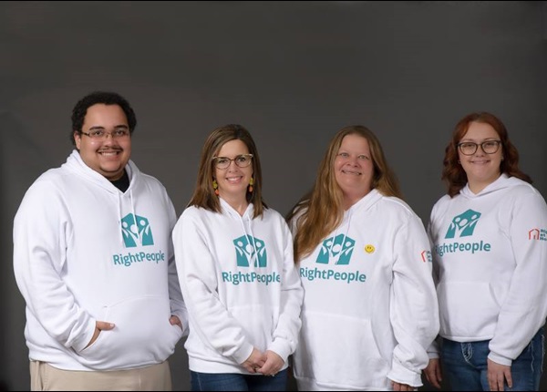 Right at Home staff photo with everyone wearing Right People white hoodies