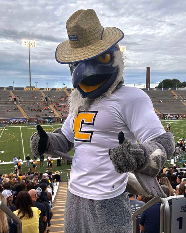 The Mocs mascot posing with a Right at Home hat.