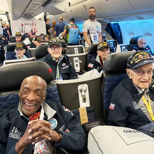 Group of Veterans Seated in a Plane Flying to Belgium