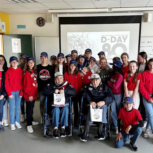 Group Photo of Men and Women with Two Senior Veterans in Wheelchairs Front and Center