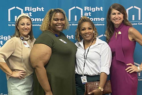 Four Women Pose for a Photo in Front of a Blue Door at an Open House in Lafayette